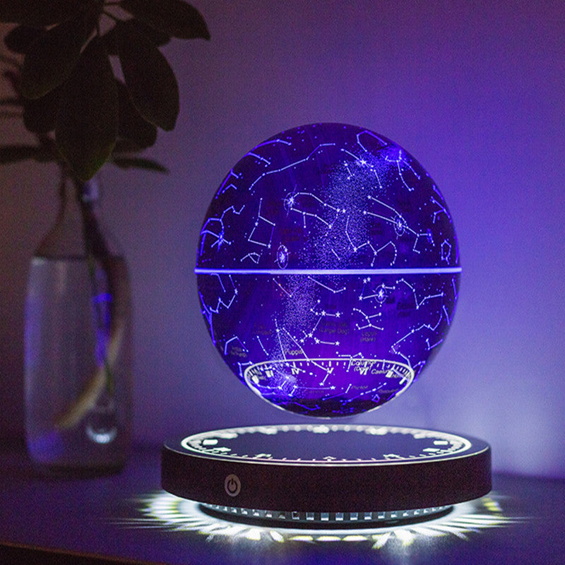 Levitating star globe lamp: blue constellation globe with white star lines floating over its black base, navy background