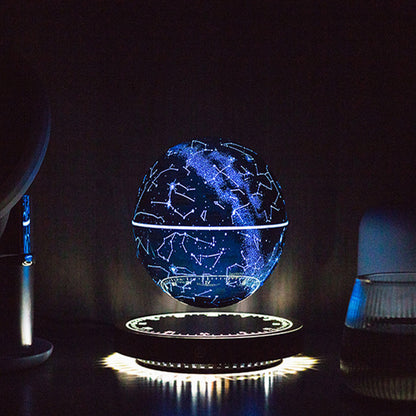Levitating star globe lamp: glowing constellation globe hovering above the lit black base, moody near-black background
